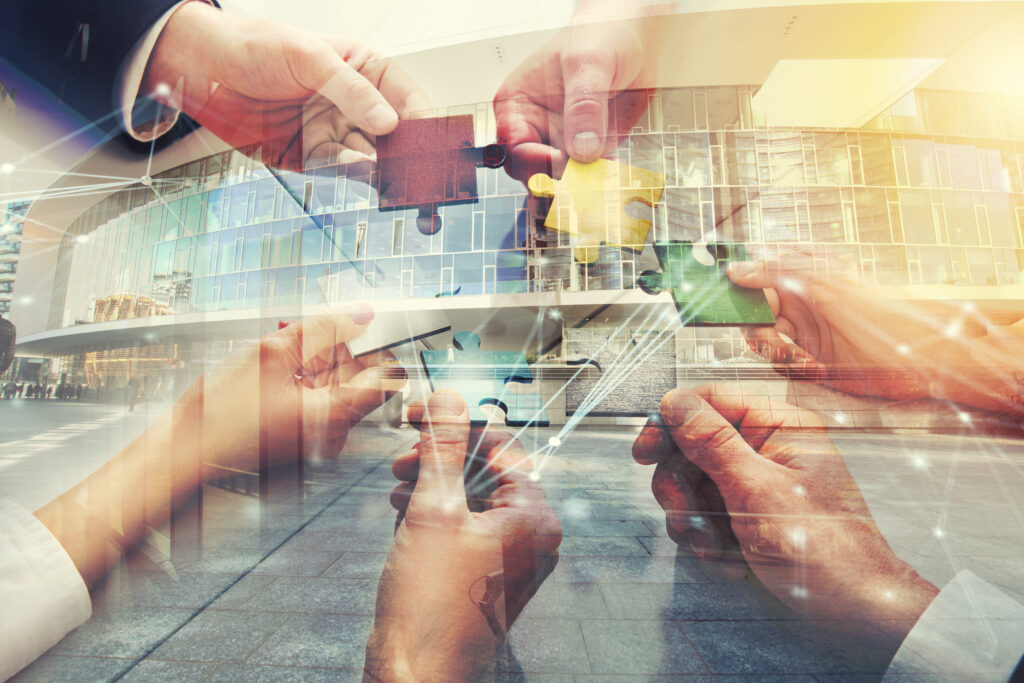 Hands coming together to solve a puzzle